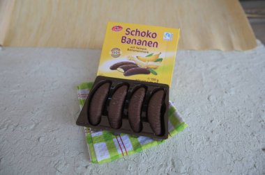 Lviv, Ukraine, March 2023.chocolate bananas ,Mini banana covered with chocolate .Mini banana and ladyfingers covered with chocolate foam.