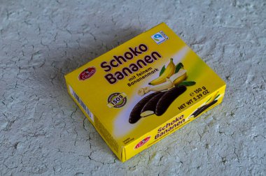 Lviv, Ukraine, March 2023.chocolate bananas ,Mini banana covered with chocolate .Mini banana and ladyfingers covered with chocolate foam.