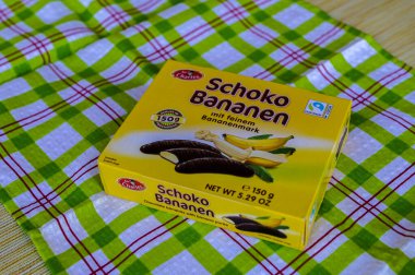 Lviv, Ukraine, March 2023.chocolate bananas ,Mini banana covered with chocolate .Mini banana and ladyfingers covered with chocolate foam.