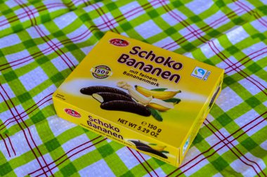 Lviv, Ukraine, March 2023.chocolate bananas ,Mini banana covered with chocolate .Mini banana and ladyfingers covered with chocolate foam.