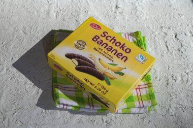 Lviv, Ukraine, March 2023.chocolate bananas ,Mini banana covered with chocolate .Mini banana and ladyfingers covered with chocolate foam.