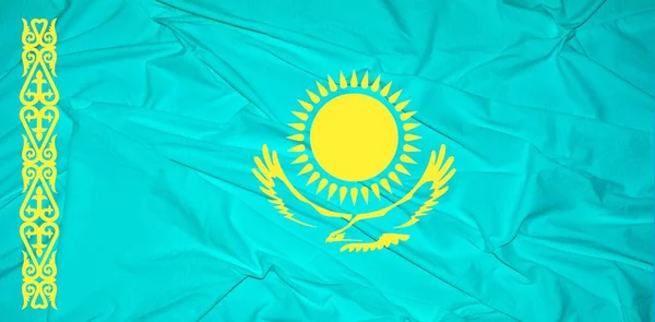 Waving flag of the Kazakhstan. Flag in the Wind. National mark. Waving Kazakhstan Flag. Kazakhstan Flag Flowing.Flag of Kazakhstan Brick wall texture .