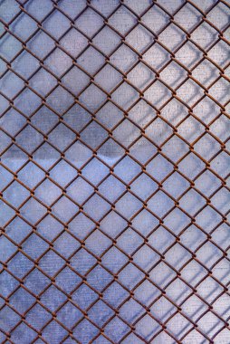 Köyde bir çit. Eski zincir zinciri, yeşil çimen tarlası arka planına sahip soyut çitler. Yumuşak, bulanık arkaplanı olan ön plana odaklan. Herhangi bir fon, özel mülk, spor alanı kavramı.