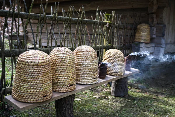 stock image Traditional dome shaped woven bee hives.A traditional domed shape woven bee hive with copy space for your text.Old-style bee hive with bee hives made out of straw.