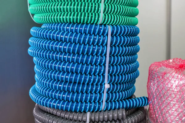 multicolored industrial plastic spiral tubes in zabod packs.Detail of colored plastic hose in spiral shape used in the construction industry for plumbing systems