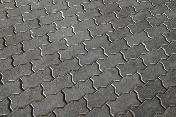 Texture of concrete pavement or sidewalk with paving slabs.Grey paving slabs as a background close-up image.