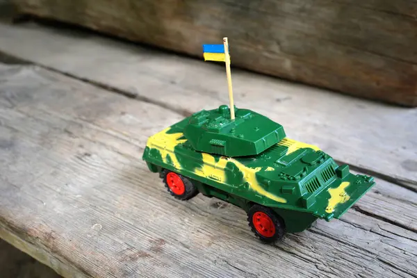 Mini models of armoured personnel carriers placed on stand. Kyiv Ukraine.a plastic children\'s toy armored personnel carrier as a symbol of war in ukraine.