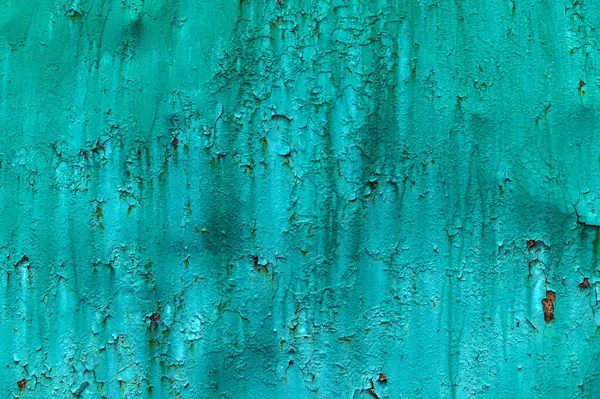 The texture of old rusty metal covered with peeling turquoise (blue, green) paint. Background for the design.
