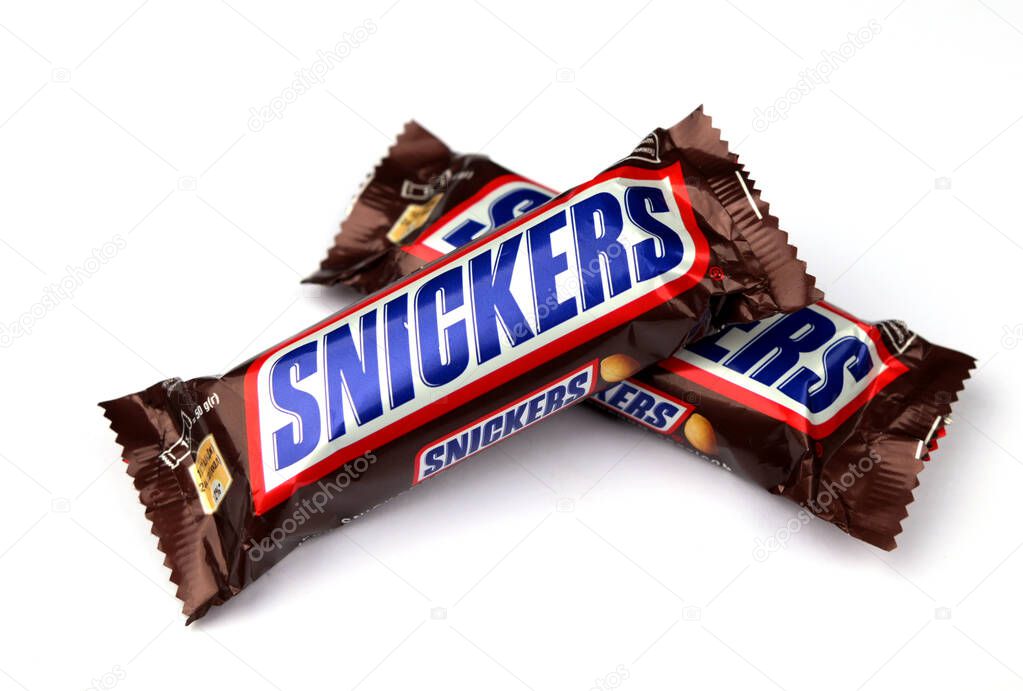 Lviv, Ukraine. January 29, 2024.Editorial illustrative image of snickers chocolate bar with peanuts, caramel and nougat closed up isolated on white