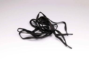 Beyaz arka planda uzun siyah ayakkabı bağcıkları