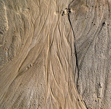 Tiny fractal landscape.Erosion pattarn on the sand.Wavy patterns in beach sand formed by wind, creating a dynamic and textured natural landscape. clipart