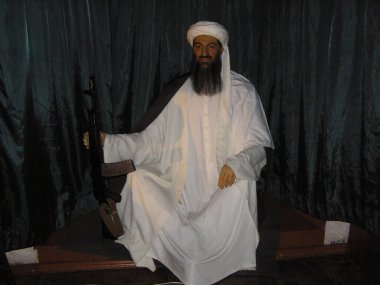 Kyiv. ukraine. July 16, 2024.A wax figure of Osama bin Laden at an exhibition of wax figures. Realistic sculpture in traditional clothes on a dark background. clipart