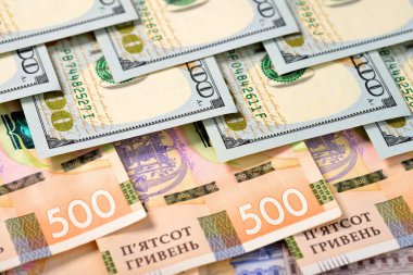 500 tane Hryvnia Ukrayna Hryvnia 'sı ve 100 dolarlık banknotlar. Yüksek açı görünümü.