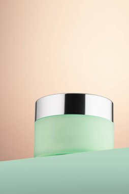 Closed glass jar of skin care cream. One object. Copy space.