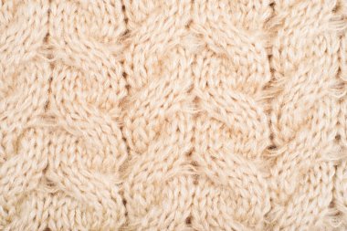 Kablolar ve örgülerle bej örülmüş dokunun rahat arka planı.