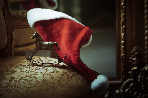 Christmas Santa Hat Rocking Horse Toy Gold Chair — Stock Photo, Image