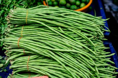 Long bean Asia food selling in the fresh market in Thailand. clipart