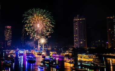 2024 yılını kutlamak için havai fişek gösterisi Chao Praya Nehri boyunca gece sahnesi ile Bangkok, Tayland 'daki Asitik kentinde.