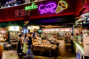 Simge Siyam 'ın bodrum katında turistler ve Tayland yemekleri ve satılık hatıraları olan ziyaretçiler için alışveriş merkezi manzarası. Seçici bir odaklanma ile. Bangkok, Tayland. - 25 Mayıs 2025.