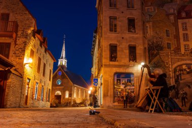 Quebec, Canada - October 22 2022 : Fresco Wall Art in the Quebec City Old Town in autumn night. Mural of Quebecers.