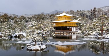 Snowy Kinkaku-ji Temple in winter. Famous tourist attraction in Kyoto, Japan. The Golden Pavilion, Kinkakuji, rokuon-ji, rokuon-ji. Snow landscape.