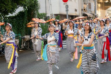 Osaka, Japonya - 25 Temmuz 2023: Tenjin Matsuri Festivali. Şemsiye dansçıları sokaklarda yürüyor..