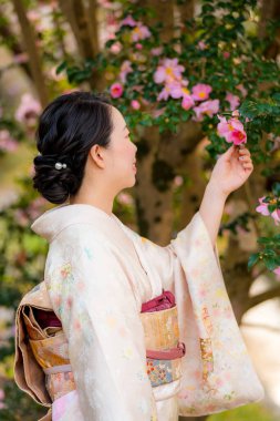 Japanese Female Kimono portrait photography with flowers in full bloom.
