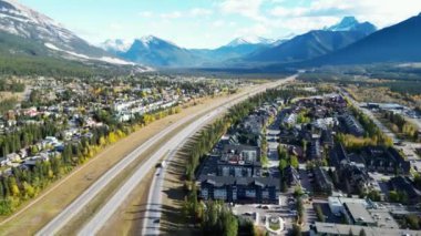 Aerial view of Trans-Canada Highway (Highway 1) exit 89 to Downtown Canmore in Canadian Rockies in a autumn sunny day. Alberta, Canada. Transportation concept.