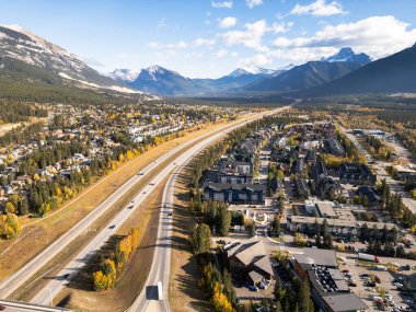 Aerial view of Trans-Canada Highway (Highway 1) exit 89 to Downtown Canmore in Canadian Rockies in a autumn sunny day. Alberta, Canada. Transportation concept.