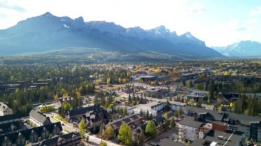 Aerial view of Town of Canmore in a autumn sunny day. Canadian Rockies mountain range in the background. Alberta, Canada.