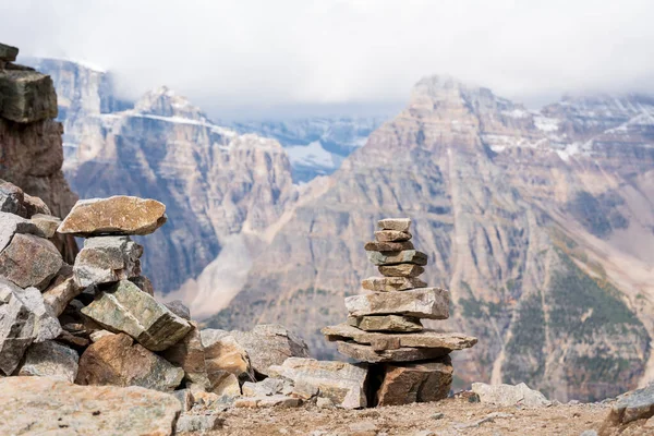 Balancing stones and mountain peak landscape in the background. Stack of stones, Pile of rocks, stones tower. Spirit of Zen.