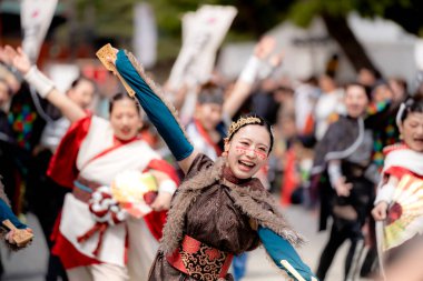 Kyoto, Japan - March 31 2024 : Kyoto Sakura Yosakoi ( Sakuyosa ) festival. A group of dancers dancing down a street at the Okazaki area around Heian Shrine. clipart