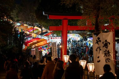 Kyoto, Japan - February 2 2024 : Yoshida Shrine Setsubun matsuri festival. Japanese traditional street vendor at night. clipart