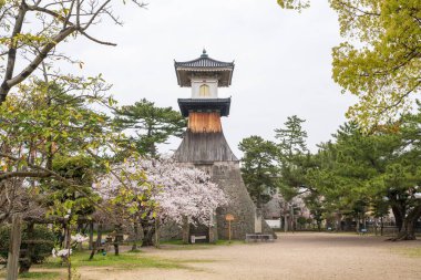 Kagawa, Japan - April 7 2024 : Kotohira Tall Stone lantern. Completed in 1860, it is the tallest stone lantern in Japan with a height of 27 meters. clipart