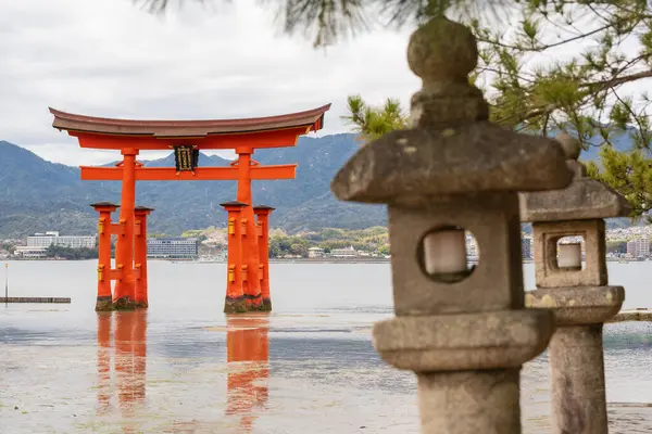 stock image O-torii ( Grand Torii Gate ) stands in Miyajima island bay beach at low tide. Itsukushima Shrine stone lanterns and pine tree. Hiroshima, Japan.