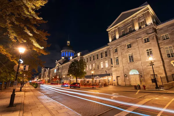 stock image Montreal, Quebec, Canada - October 18 2022 : De la Commune Street (Rue de la Commune) in Old Montreal at night. Bonsecours Market (Marche Bonsecours).