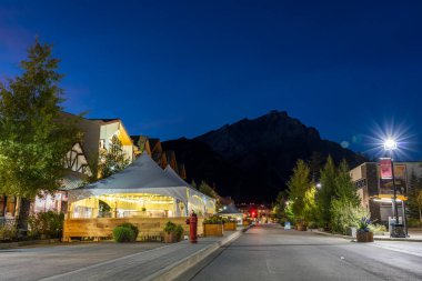 Banff, Alberta, Kanada - OCT 03 2020: gece Banff Avenue sokak manzaralı. Banff Ulusal Parkı, Kanada Kayalıkları.