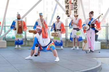 Tokushima Prefecture, Japan - August 14 2024 : Tokushima Awa Odori Festival 2024. Performers are performing Japanese traditional Awa dance on the outdoor stage. clipart