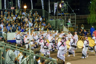 Tokushima Prefecture, Japan - August 14 2024 : Tokushima Awa Odori Festival 2024. Narimono musicians playing the shamisen lute, taiko drums, shinobue flute and the kane bell. clipart