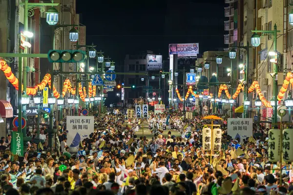 stock image Tokushima Prefecture, Japan - August 14 2024 : Tokushima Awa Odori Festival 2024. Performers wear traditional obon costumes, dance and sing as they parade through the streets at night.