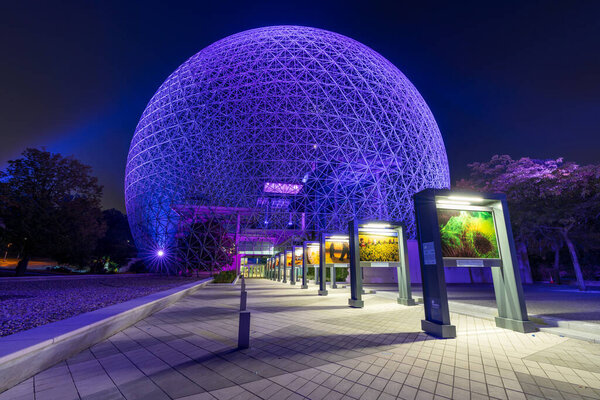 Montreal, Quebec, Canada - August 5 2021 : Montreal Biosphere illuminated at night. Jean-Drapeau park, Saint Helens Island.
