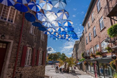 Quebec, Canada - October 20 2021 : Umbrella Alley. Quebec City Old Town street view in autumn sunny day. clipart