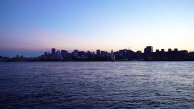 Montreal 'in eski limanı ve geceleri gökyüzü. Renkli binaların ışıkları suya yansıyor. Montreal şehri, Quebec, Kanada.