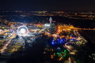 Niagara Falls, Ontario, Canada - December 19 2021 : Overlooking the Niagara Falls City downtown night view. clipart