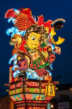 Goshogawara, Aomori, Japan - August 7 2024 : A massive Tachineputa float parades through crowded streets during the Goshogawara Tachineputa Festival night parade.