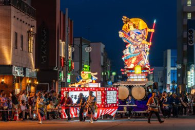 Goshogawara, Aomori, Japan - August 7 2024 : A massive Tachineputa float parades through crowded streets during the Goshogawara Tachineputa Festival night parade.