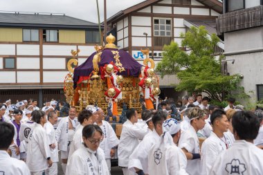 Arashiyama, Kyoto, Japan - May 25, 2025 : Saga Matsuri Kanko-sai festival Nonomiya Shrine mikoshi, a sacred purple portable shrine paraded through the streets.