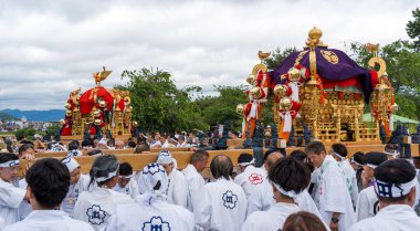 Arashiyama, Kyoto, Japan - May 25, 2025 : Saga Matsuri Kanko-sai festival Nonomiya Shrine mikoshi, a sacred purple portable shrine paraded through the streets.