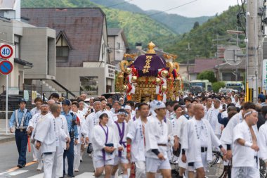 Arashiyama, Kyoto, Japan - May 25, 2025 : Saga Matsuri Kanko-sai festival Nonomiya Shrine mikoshi, a sacred purple portable shrine paraded through the streets.