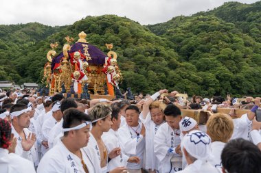 Arashiyama, Kyoto, Japan - May 25, 2025 : Saga Matsuri Kanko-sai festival Nonomiya Shrine mikoshi, a sacred purple portable shrine paraded through the streets.